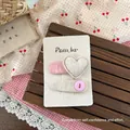 Detail of sweet fabric hair clips with padded heart and button on branded card - Square Heart and Drop Button Clip