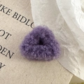 Macro shot of fluffy purple faux fur hair claw clip with lamb wool texture and cat ear shape - Purple Claw Clip