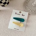Close-up of matte waterdrop BB clips in green and yellow on a handmade display card - Dark Green And Off White Water Drop Style