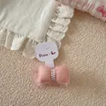 Close-up of pink mesh bow hair tie with faux pearls on brand display card for girls - Pink Bowknot