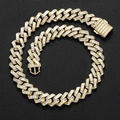 Detailed macro view of 16mm gold cuban link chain with baguette-cut zircon stones - 16" / Gold