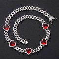Macro shot of silver hip hop Cuban link chain with sparkling red heart-shaped stones - Necklace / Red Zircon Heart Silver