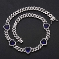 Macro detail of silver Cuban chain necklace featuring heart-shaped blue zircon stones - Necklace / Blue Zircon Heart Silver