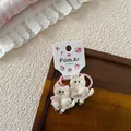 Detalle de coletero de gato bordado rosa con vestido de lentejuelas en tarjeta floral - Gomas de Pelo de Gato Par