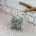 Detail of sweet green striped mesh bow hair ties with delicate white lace lining - Green