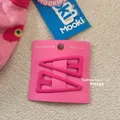 Close-up of two matte pink triangle hair clips on a display card for bangs styling - Rose Red (2)