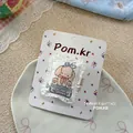 Close-up of a sweet cartoon dog fabric hair clip on floral display card with lace background - Blue Bunny Pillow Hair Clip