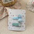 Detail von blauen Haarschleifen mit Perlen und Paillettensternen auf Displaykarte - Blaugrünes Gesticktes Schleifen-Clip-Set