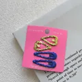 Detail of four glittery heart and teardrop hair clips in gold and blue on display card - Set of 4 / Gold Heart + Dark Blue Waterdrop