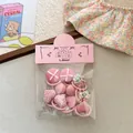 Set di elastici per capelli rosa con cuori in tessuto e bottoni in busta trasparente - Elastico Pollice Fagiolo Rosa