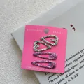 Close-up of four glittery silver and purple sequin hair clips on pink display card - Set of 4 / Silver Heart + Purple Red Waterdrop
