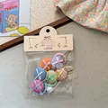 Détail de chouchous à boutons en tissu coloré avec ruban et emballage mignon - Élastique Pouce Haricot Multicolore