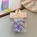Dettaglio del set di elastici per capelli viola con motivi a cuore e stella in pacchetto - Elastico Pollice Fagiolo Viola