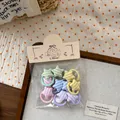 Detailopname van kleurrijke gestreepte ster haar elastiekjes voor kinderen in macaron tinten - Ster Twill Duim Haarelastiekje