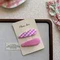 Detail view of two-piece pink floral and checkered hair clips on a display card - Water Drop Plaid BB Clip