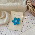 Vista detallada de una pinza para el cabello de flor azul Morandi en tarjeta mate - Pinza de Flor Azul Claro