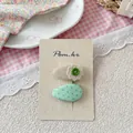 Détail d'une barrette en dentelle florale et clip en tissu à pois sur carton - Barrettes à Pois Verts