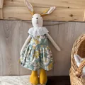 Detail of linen bunny plush in green floral dress with lace collar on wooden background - Green Floral Style