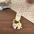 Detail of embroidered cat hair tie with yellow elastic bands on premium wood desk - Yellow Cat