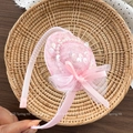 Detailed view of pink sequin bow and faux pearl accents on a sweet girl's hairband - Hat Style Headband / Pink