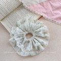 Detail of floral scrunchie with white lace trim and blue flower patterns on soft chiffon - Blue Floral