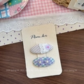 Detail showing two embroidered fabric hair clips with lace and purple flower patterns - Striped Embroidery Style / Purple Button Hair Clip