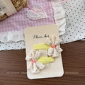 Detailed macro view of yellow fabric hair clips with lace bows and small red beads decoration - Lace Beads Yellow Hair Clip