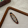 Close-up of tortoise shell pattern oval hair clip with silver metal snap base - Large Oval BB Clip (NK2084-2)