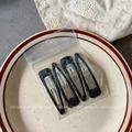 Set of four vintage black square hair clips in transparent retail packaging on a ceramic dish - Black Waterdrop