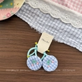 Detailed view of blue checkered hair ties with handmade beaded cherry patterns on a card - Blue Plaid Hair Ties