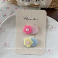 Close-up of floral fabric hair clips in pink and blue on a natural display card - Flower Design (NK2152) / Pink and Blue Floral Hair Clip