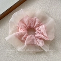 Detail view of pink plaid fabric hair tie with cream mesh and metallic bead accents - Pink