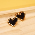 Detail of heart stud earrings with golden hammered edges and black enamel finish - Black