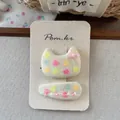 Detail of fabric hair clips with colorful heart patterns and a pink ribbon bow on card - Cat Print Hair Clip