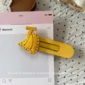 Detailed close-up of a yellow banana hair clip with precision stitching and metal clamp - Yellow Banana Hair Clip