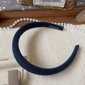 Detail of navy blue fabric headband featuring a stitched Hand Made woven label - Blue Thin Headband