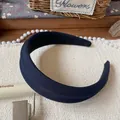 Close-up of wide blue checkered fabric headband with twill texture and retro style design - Blue Wide Headband