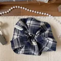 Detail of blue plaid fabric scrunchie with a white handmade label and soft pearl decor - Blue Plaid Scrunchie