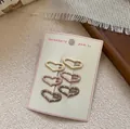 Set of six heart shaped hair clips with polka dots in cream and pink on a display card - Mini Heart Style