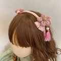 Close-up of pink flower headband with velvet petals, pearls and long tassels decor - Pink Peach Blossom Bow Hairband