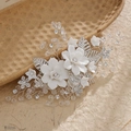 Elegant silver bridal hair comb with white ceramic flowers and crystal leaves on paper - Hs-j6097