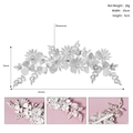 Detail view of silver flower bridal hair clip with rhinestones and matte white petals - Silver