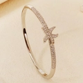 Elegant gold bangle featuring a shimmering zircon starfish design with a secure metal clasp - Silver Starfish Style (BS-J5658S)