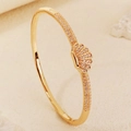 Elegant gold-tone bangle with shell motif and shimmering pavé set cubic zirconia stones - Gold Shell Style (BS-J5660G)