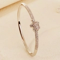 Silver finish ocean turtle bangle with sparkling cubic zirconia on beige display stand - Silver Turtle Style (BS-J5661S)