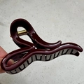 Detail of burgundy hair claw clip with a glossy finish and premium gold spring - 11.5cm Irregular Shape Style