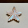 Close-up of a star-shaped hair claw in pink resin with iridescent blue glitter detail - Light Orange Glitter Star Patch Claw Clip
