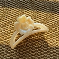 Detailed close-up of cream pearlescent resin flower hair claw clip on knit fabric - Semi-Circle Claw / Beige