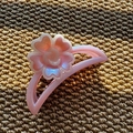 Detail showing pink floral hair claw clip with pearlescent resin petals on a textured surface - Semi-Circle Claw / Purple Pink
