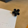 Koreanische schwarze Blumenohrstecker mit grünem Kristall auf einer Displaykarte - Schwarz
